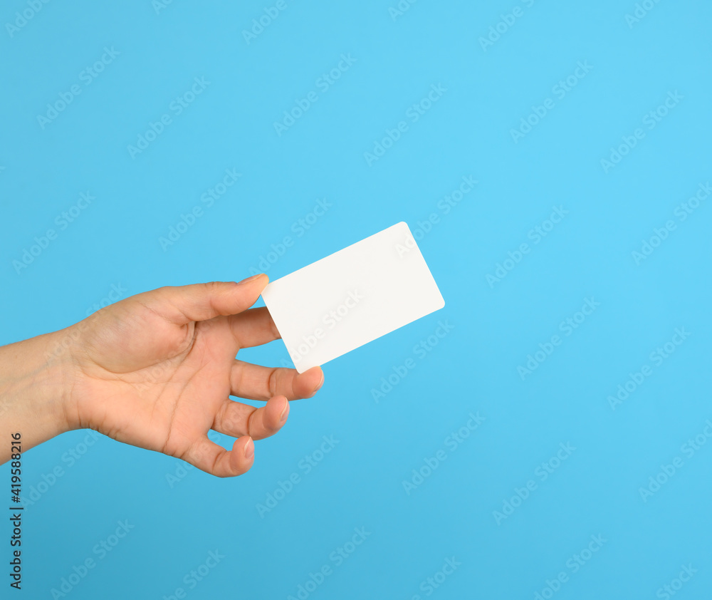 female hand holding a white black business card female hand holding a white black business card