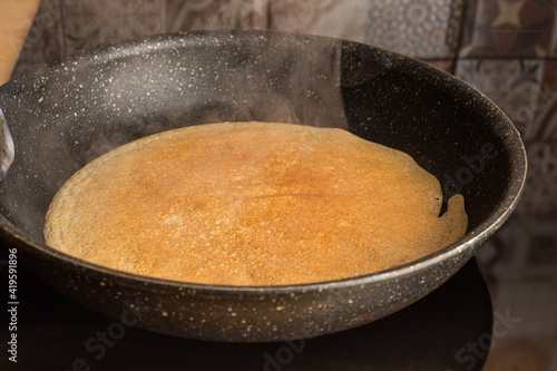 Frying cooking pancake on a frying pan. Home cooking