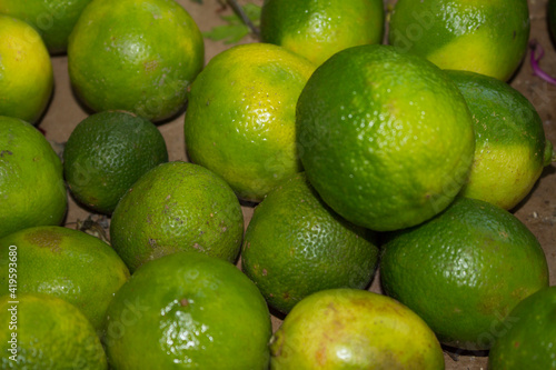 Lemons at the supermarket. Tahiti lemon (Citrus × latifolia). Lemons for the consumer to choose and buy usually sold by weight. photo