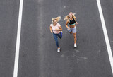Two young females jogging at the city street.High angle view.