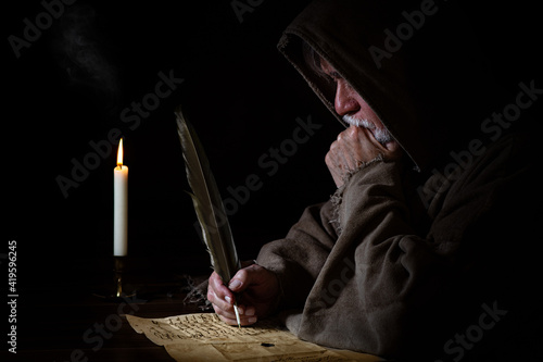 Fotografia Medieval poor monk writes letter