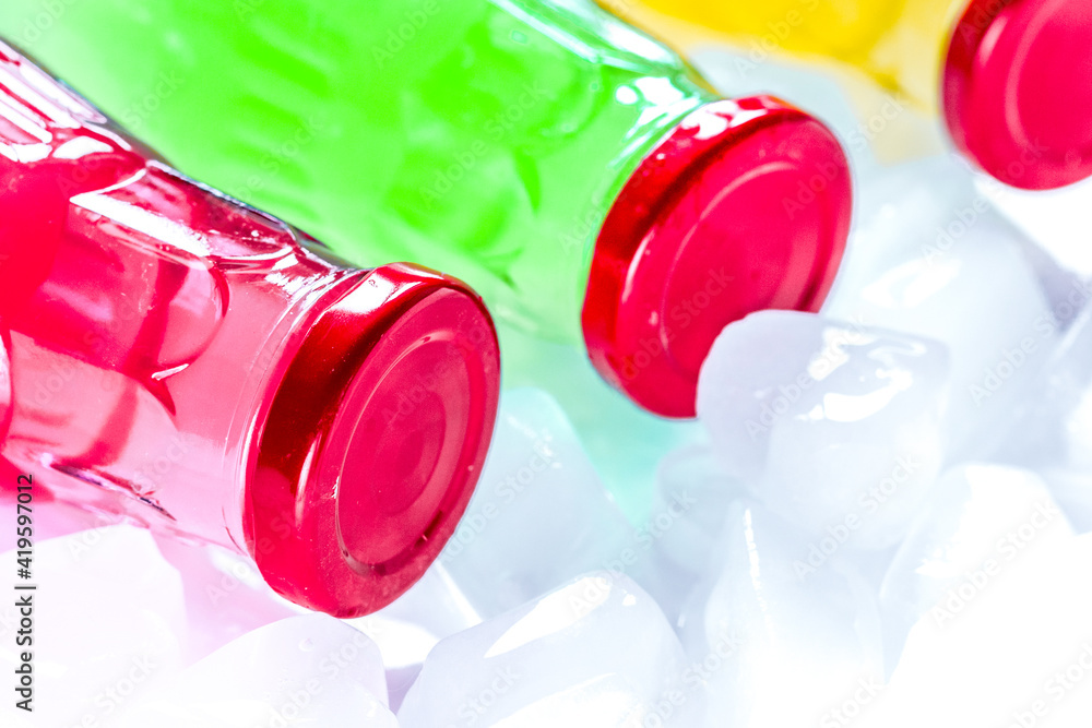 plastic bottles with fruit juice and ice space for text plastic bottles with fruit juice and ice space for text