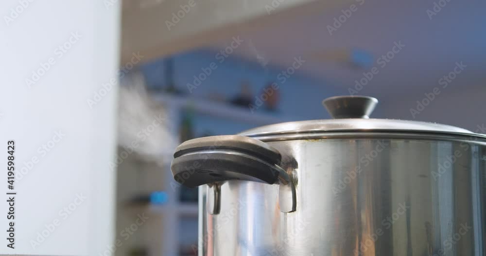 Close up and focus on foreground on steaming pot. Low angle and static shot Close up and focus on foreground on steaming pot. Low angle and static shot