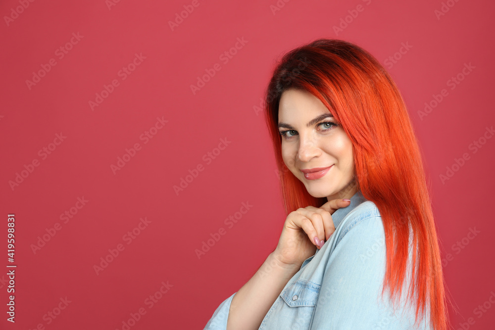 Young woman with bright dyed hair on red background. Space for text Young woman with bright dyed hair on red background. Space for text