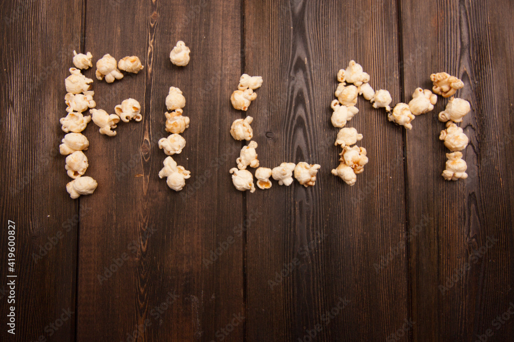 popcorn laid out word movie on wooden background snack popcorn laid out word movie on wooden background snack
