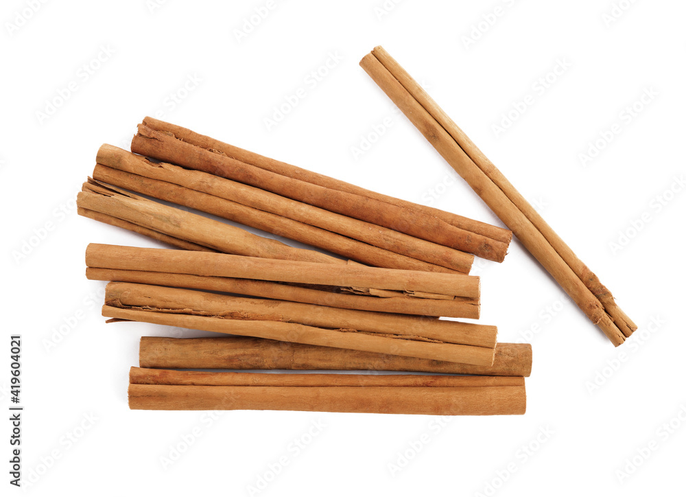 Aromatic dry cinnamon sticks on white background, top view