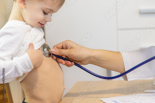 child being checked by a doctor. Selective focus
