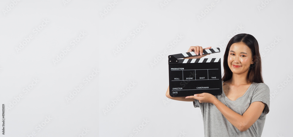 Black clapper board or movie clapperboard in hand of teenage Girl or woman . it use in video production ,cinema industry on white background. Black clapper board or movie clapperboard in hand of teenage Girl or woman . it use in video production ,cinema industry on white background.