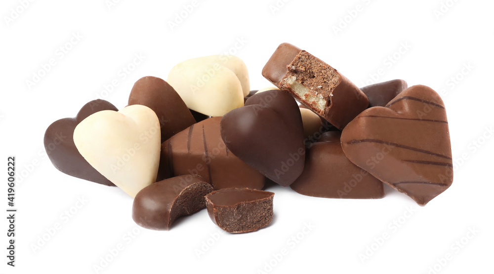 Fototapeta premium Delicious heart shaped chocolate candies on white background