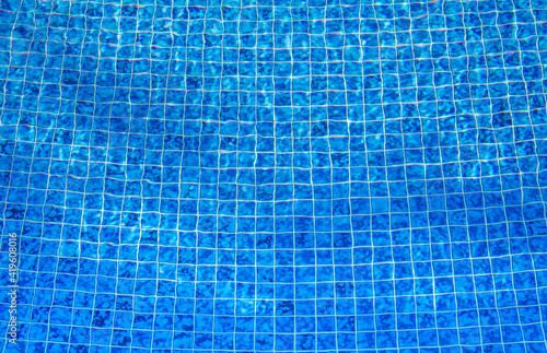 Blue Tile Lining of a swimming pool. Concept of evoke Vacation, sunshine and refreshment. Used for background or wallpaper