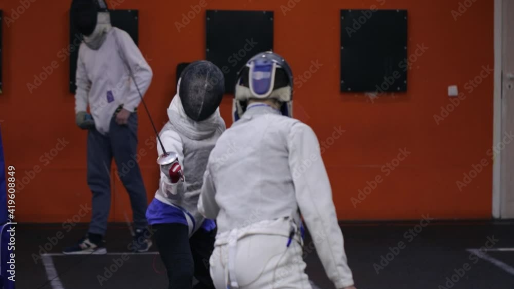 Teenagers practicing fencing at a fencing school Teenagers practicing fencing at a fencing school