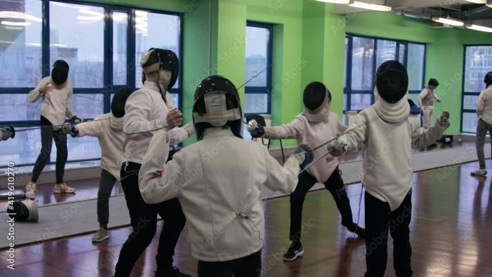 Kids practicing fencing at a fencing school Kids practicing fencing at a fencing school