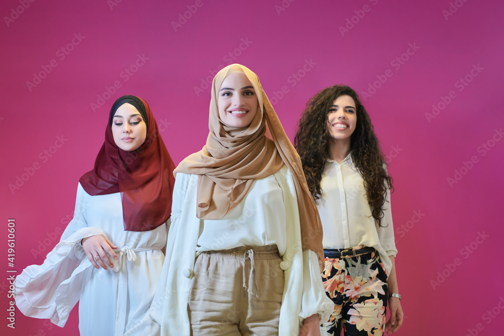 Young muslim women posing on pink background