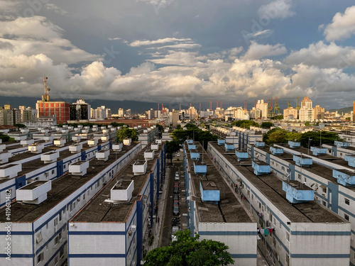 Perspective aerial view of the neighborhood of Aparecida from the housing project to the port of Santos on a sunny afternoon with clouds. photo