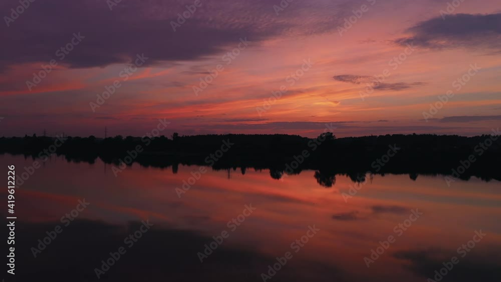 Evening sunset over a lake with romantic sky. Aerial drone view. Evening sunset over a lake with romantic sky. Aerial drone view.