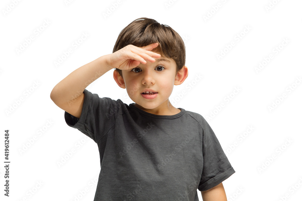 Looking for. Happy, smiley little caucasian boy isolated on white studio background with copyspace for ad. Looks happy, cheerful. Childhood, education, human emotions, facial expression concept. Looking for. Happy, smiley little caucasian boy isolated on white studio background with copyspace for ad. Looks happy, cheerful. Childhood, education, human emotions, facial expression concept.