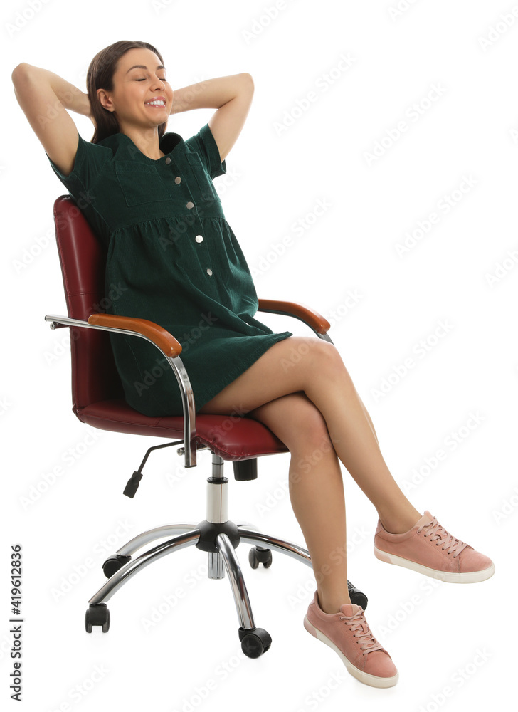 Fototapeta premium Young woman relaxing in comfortable office chair on white background