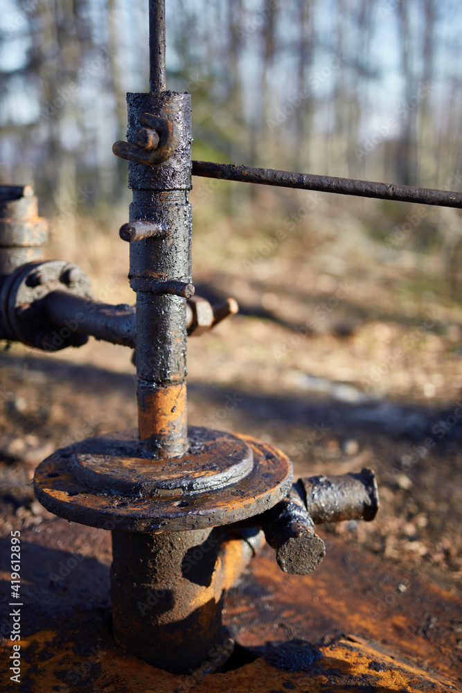 valve of the old land oil drilling rig in the forest