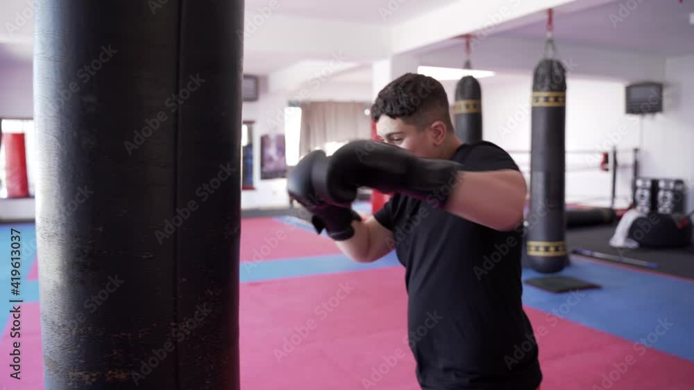 Overweight kickboxer with the heavy bag Overweight kickboxer with the heavy bag