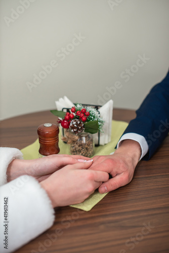 the bride and groom hold each other's hands on the table