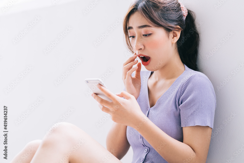 Beautiful young Asian woman using smartphone at home Beautiful young Asian woman using smartphone at home