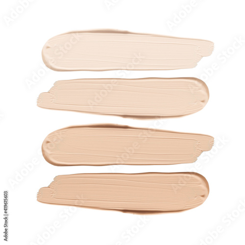 Smears of liquid foundation isolated on white background. Set of different skin tone cream swatches for makeup. photo