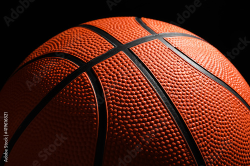 Orange basketball ball on black background, closeup © New Africa