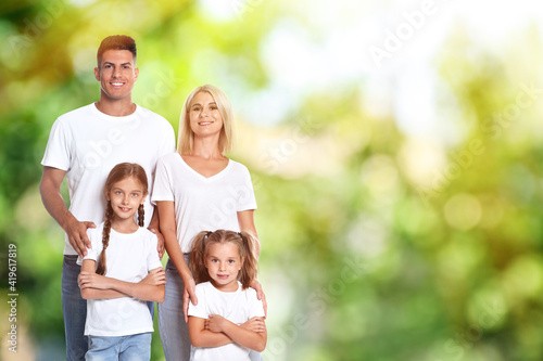 Happy family with children outdoors on sunny day, space for text