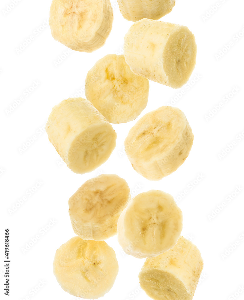 Slices of tasty ripe banana falling on white background Slices of tasty ripe banana falling on white background