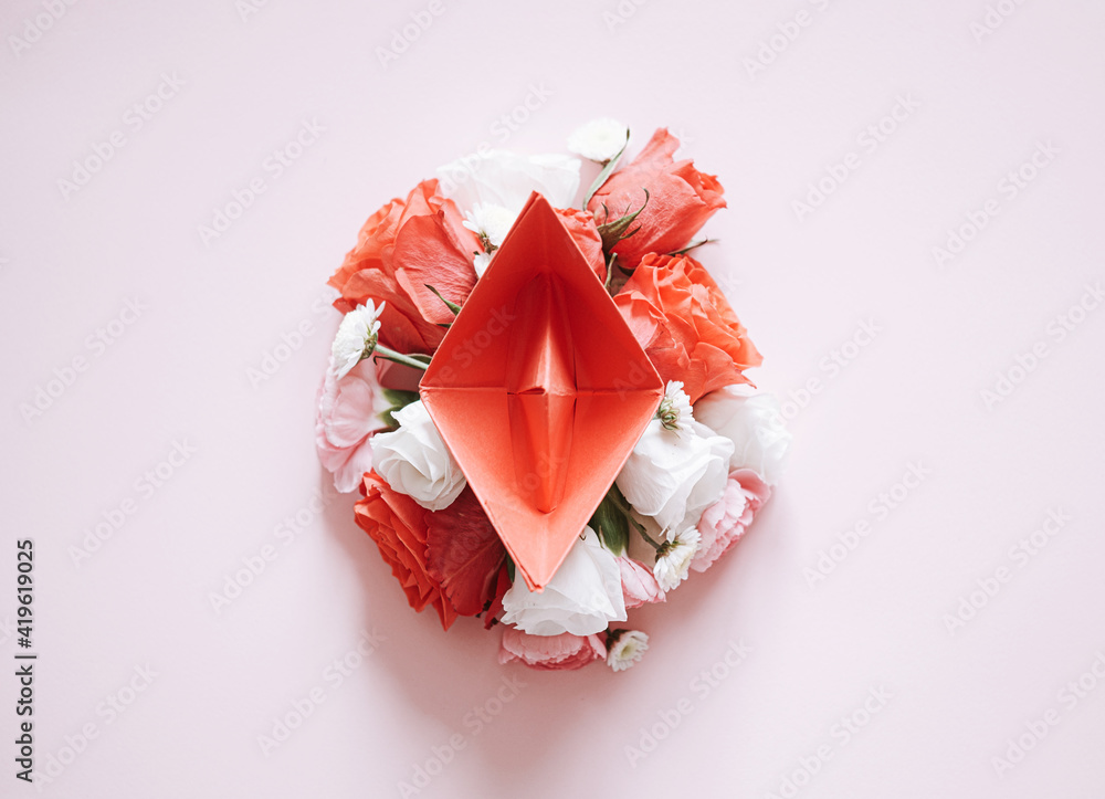 women Health. red paper boat on flower buds. abstract symbolic image of the female reproductive system