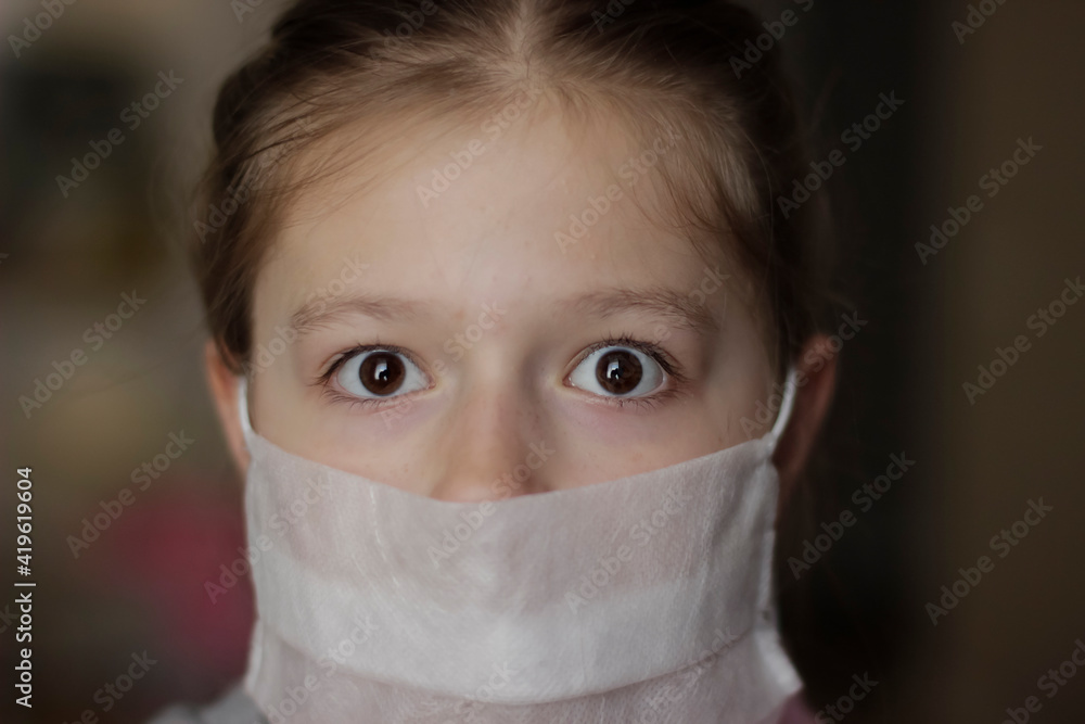 Little european girl wearing mask for protect pm2.5 and Covid-19. Sick child Little girls look at the camera posing in the studio in a red dress with a medical mask on her face. Little european girl wearing mask for protect pm2.5 and Covid-19. Sick child Little girls look at the camera posing in the studio in a red dress with a medical mask on her face.