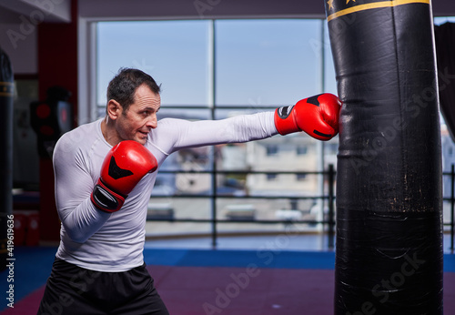 Kickboxer hitting the heavy bag in the gym