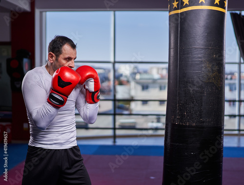 Kickboxer hitting the heavy bag in the gym