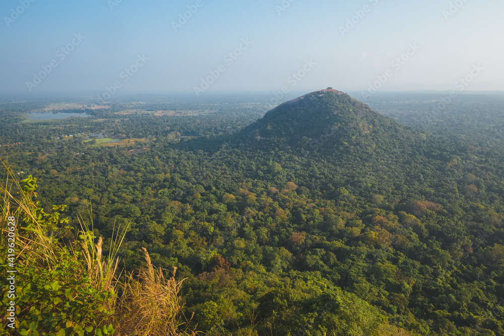 Landscape view of Pidurangala Hill  and surrounding jungle from atop Sigiriya Rock Fortress in Sri Lanka.