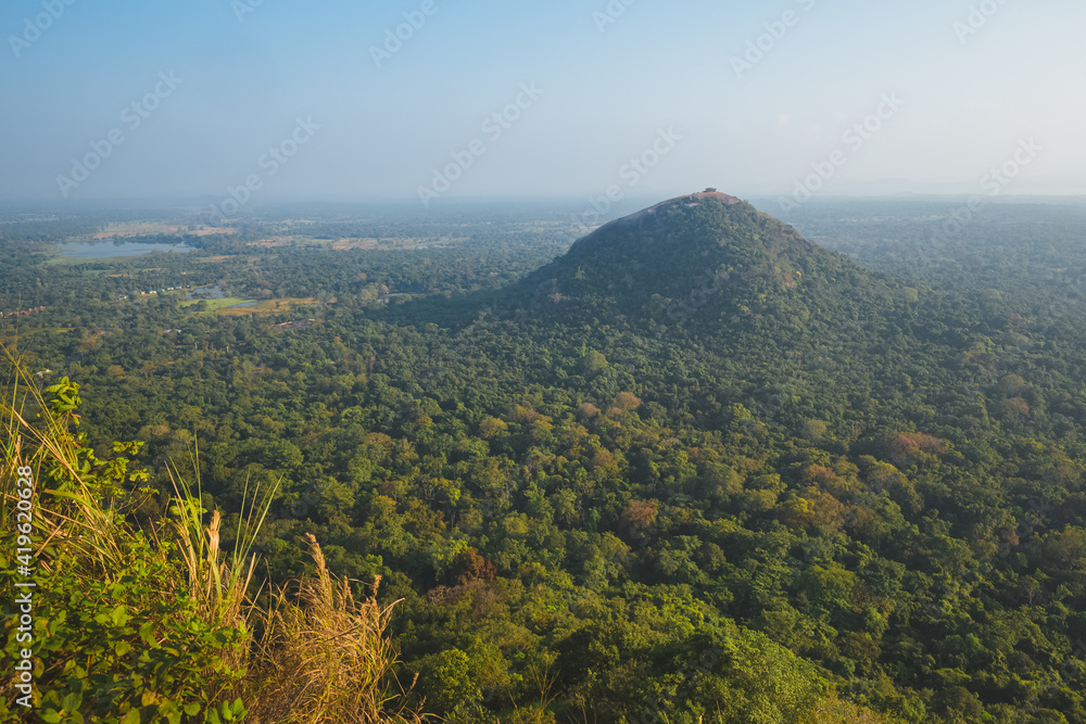 Obraz premium Landscape view of Pidurangala Hill and surrounding jungle from atop Sigiriya Rock Fortress in Sri Lanka.
