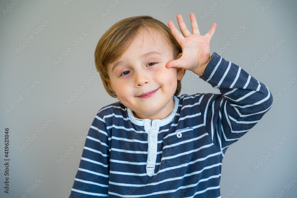 Adorable little toddler boy showing five fingers in the palm of his hand. Child smiling. Early education. Adorable little toddler boy showing five fingers in the palm of his hand. Child smiling. Early education.