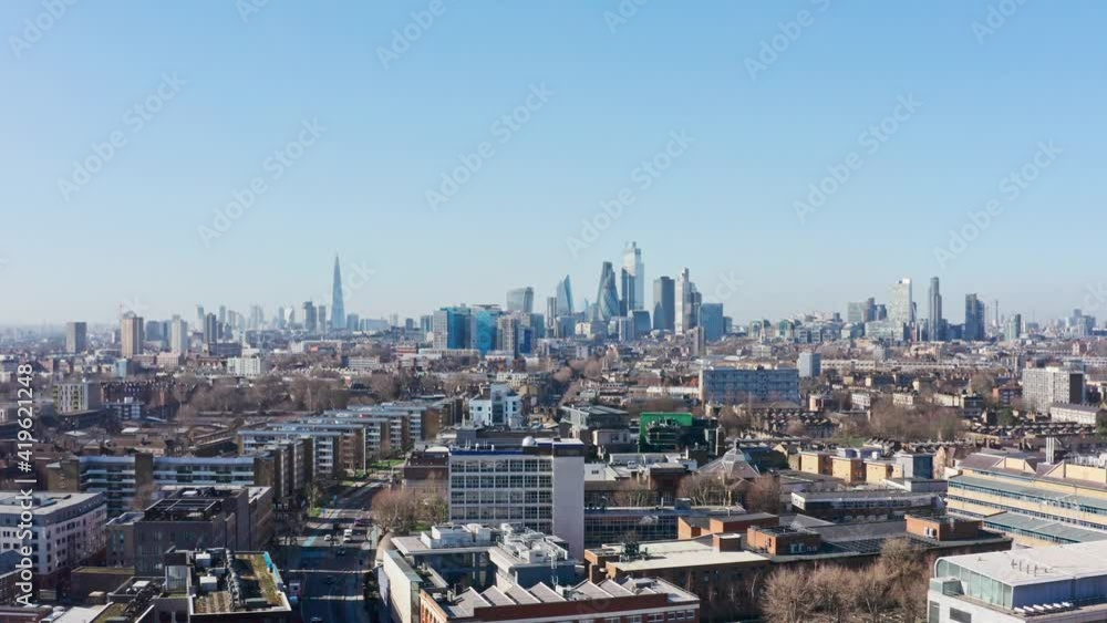 descending drone shot over residential buildings tower hamlets mile end towards city of London skyscrapers descending drone shot over residential buildings tower hamlets mile end towards city of London skyscrapers