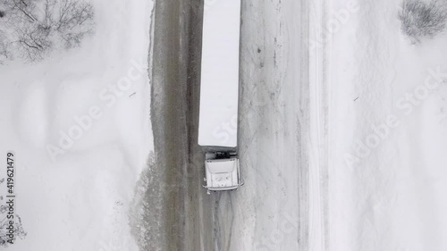 Wallpaper Mural Flying an aerial drone. A truck is skidding, trying to climb a snow-covered road uphill during a snow storm. Torontodigital.ca