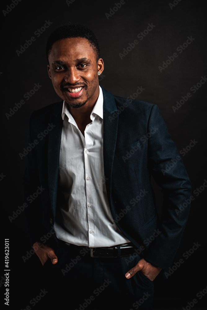 portrait of attractive, beautiful, serious and stylish professional African American businesswoman in dark suit and white shirt isolated on dark background. Low key. Selective focus portrait of attractive, beautiful, serious and stylish professional African American businesswoman in dark suit and white shirt isolated on dark background. Low key. Selective focus