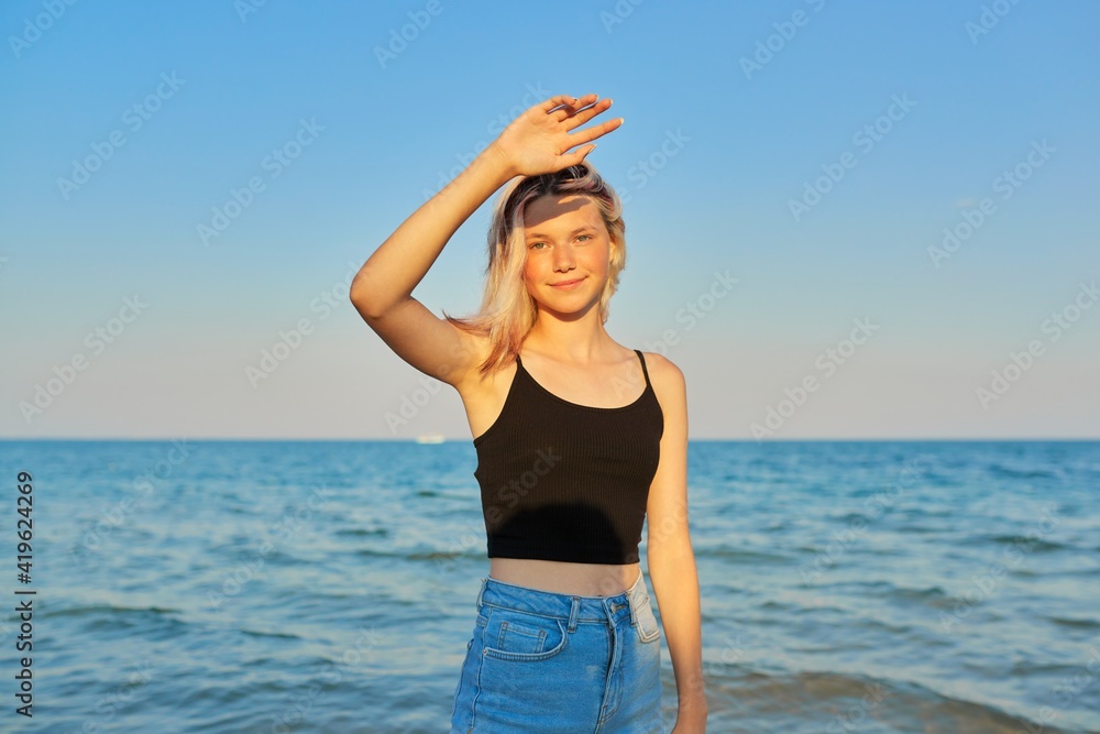 Young smiling blonde model, vacation and relaxation on the seashore Young smiling blonde model, vacation and relaxation on the seashore