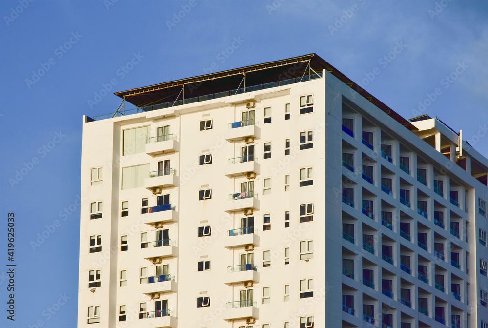 Large apartment building with white facade and balconies