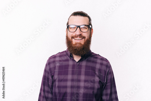 Portrait of bearded young man wearing eyeglasses and smiling © Vulp