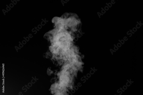 Figured smoke on a dark background. Abstract background, design element, for overlay on pictures. © Alena