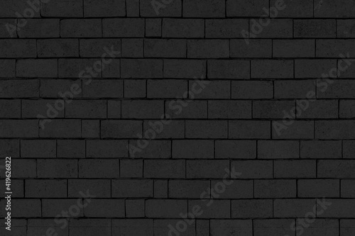 Vintage black stone brick wall pattern and background seamless