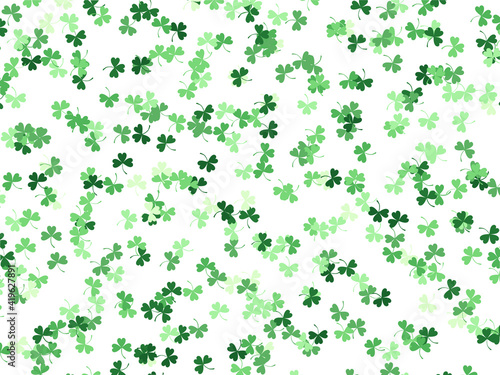 Background with clover leaves of different shades of green. A pattern for St. Patrick s Day. Vector graphics