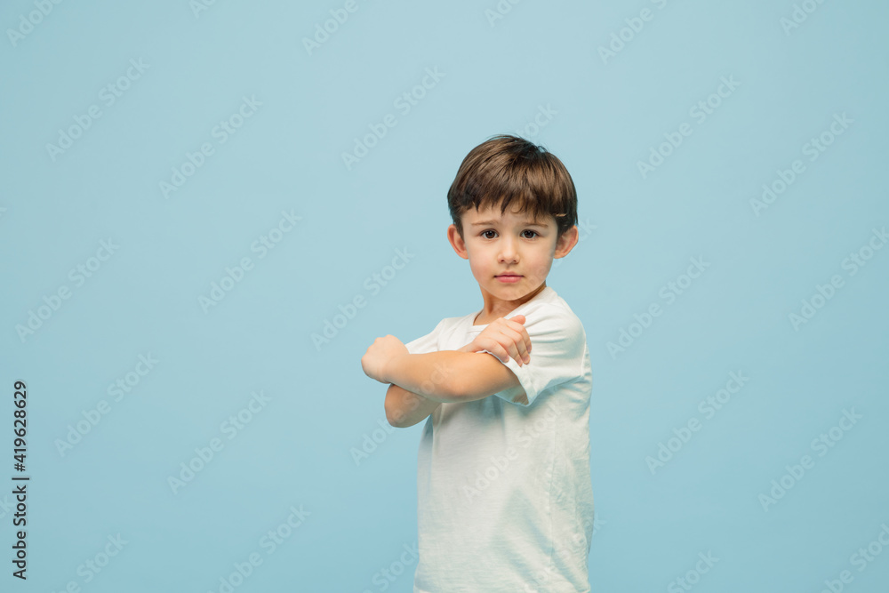 Businessman. Happy, smiley little caucasian boy isolated on blue studio background with copyspace for ad. Looks happy, cheerful. Childhood, education, human emotions, facial expression concept. Businessman. Happy, smiley little caucasian boy isolated on blue studio background with copyspace for ad. Looks happy, cheerful. Childhood, education, human emotions, facial expression concept.