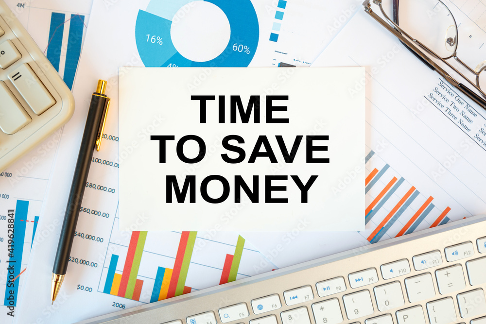 Obraz premium TIME TO SAVE MONEY is written in a document on the office desk, diagram and keyboard