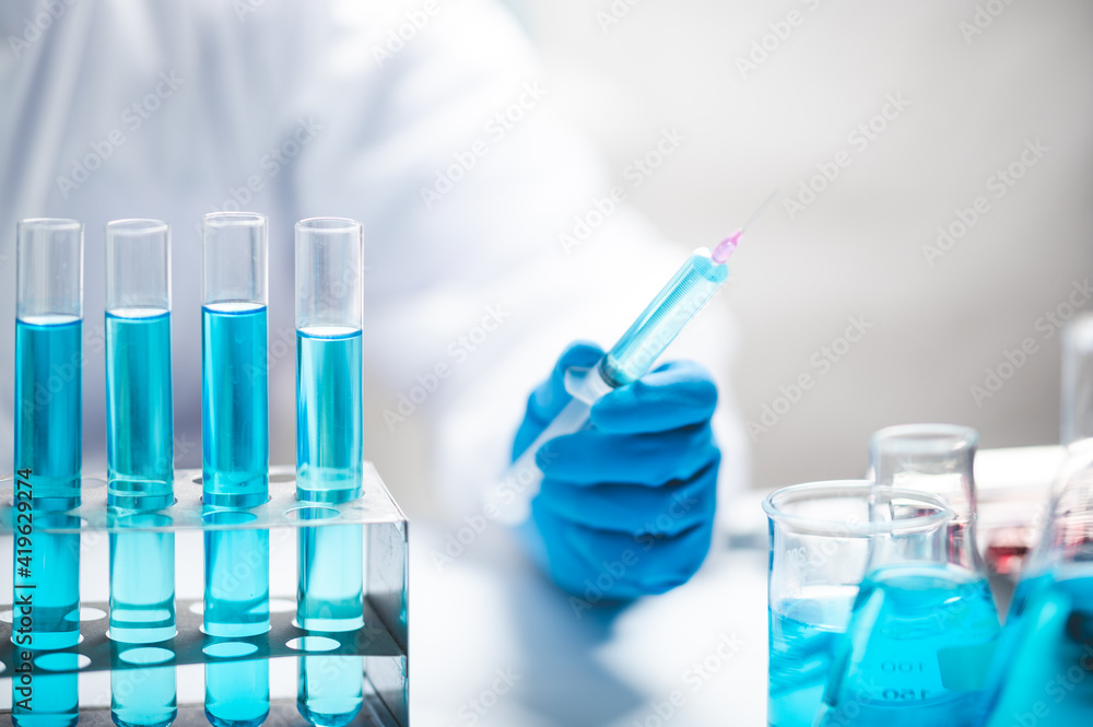 Researchers scientist working analysis with blue liquid test tube in the laboratory, chemistry science or medical biology experiment technology, pharmacy development solution Researchers scientist working analysis with blue liquid test tube in the laboratory, chemistry science or medical biology experiment technology, pharmacy development solution