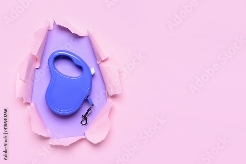 Retractable leash for dog on color background photo