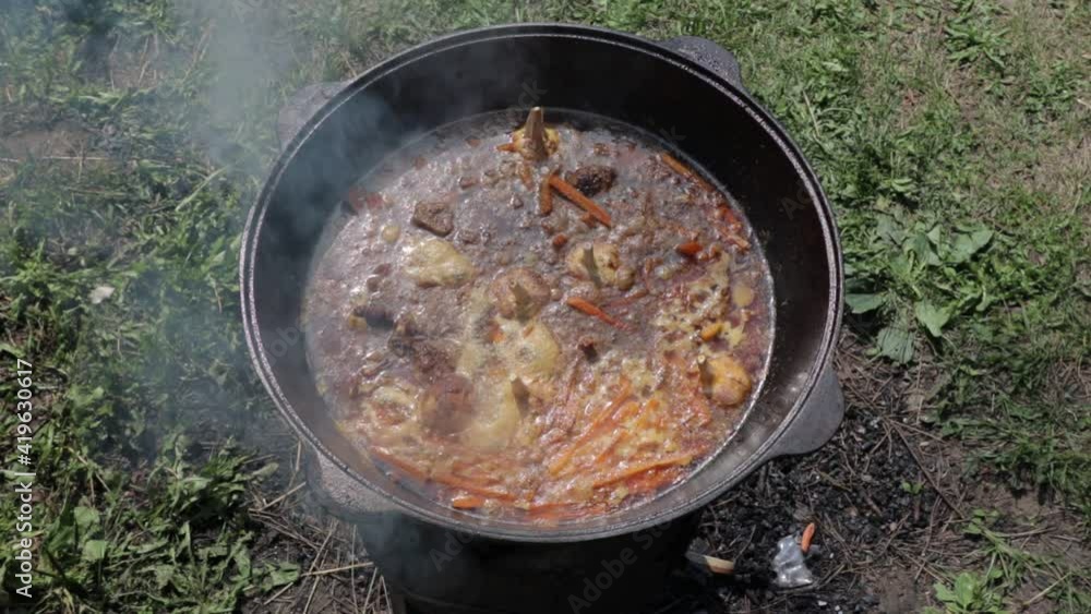 pilaf in a cauldron on fire an oriental dish on a sunny day pilaf in a cauldron on fire an oriental dish on a sunny day